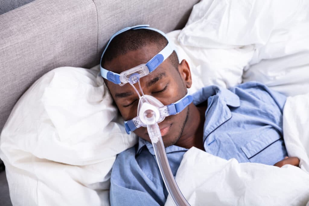 Man sleeps while using CPAP machine from You Can Home Medical