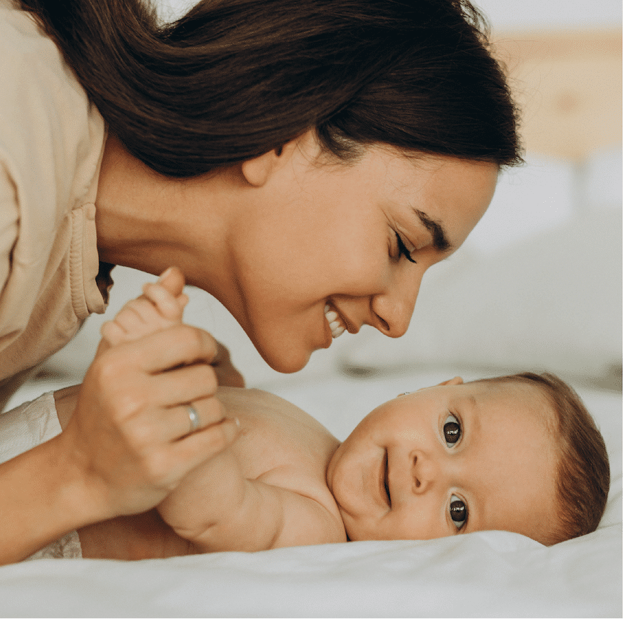 A mother smiling with her baby, thanks to a breast pump from Alpine Home Medical in Utah and Idaho
