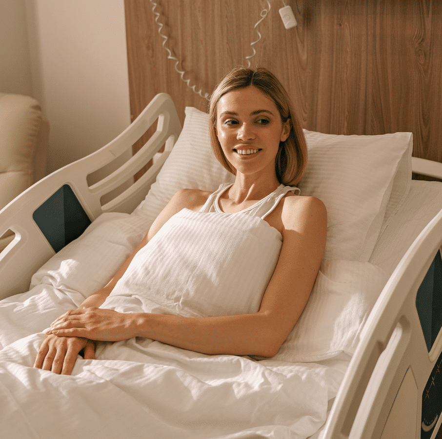 A woman sitting comfortably in a hospital bed at home, thanks to the hospital beds for sale in UT & ID from Alpine Home Medical