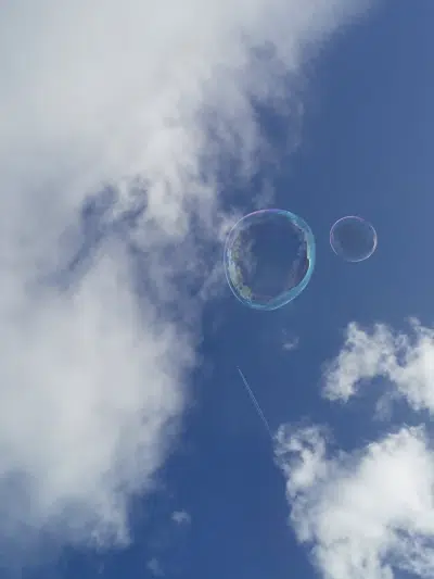 A blue sky with clouds and bubbles, symbolizing oxygen